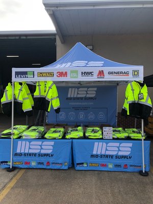 Mid-States Supply tent with Safety Main Lightweight High Visibility Jacket hanging and on desk